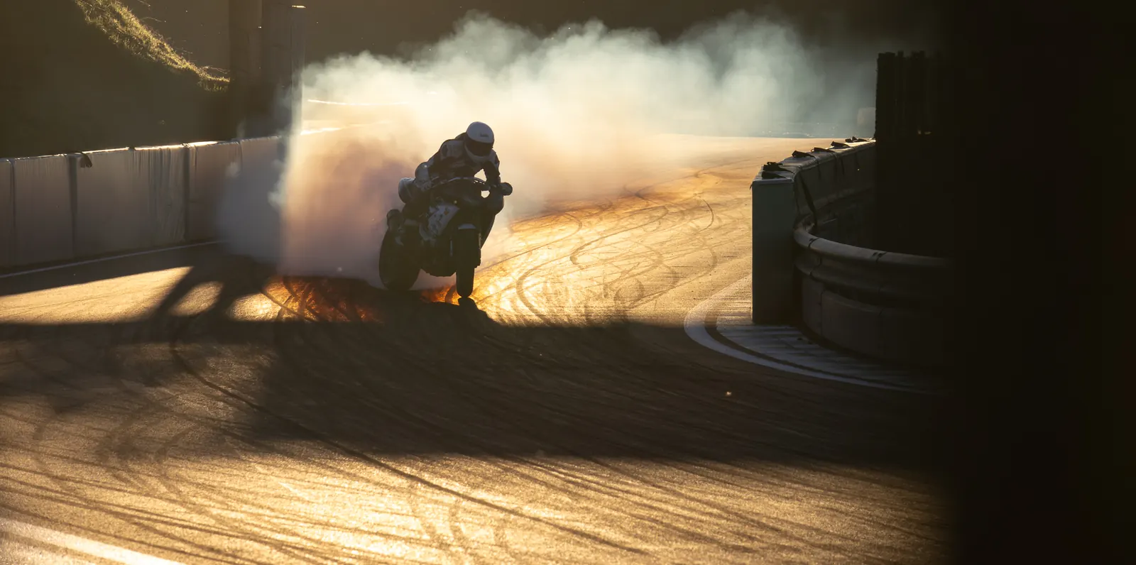 Motorbike burnout lit from behind